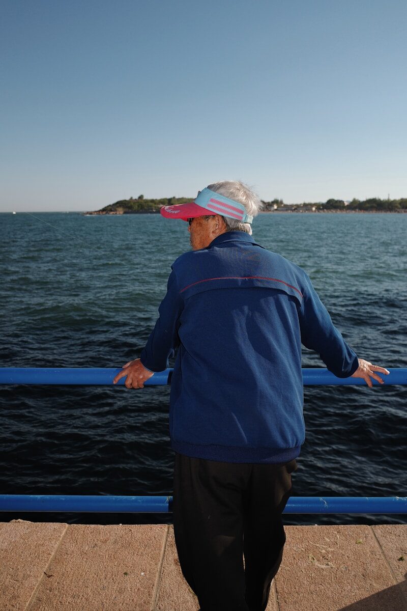 Elderly person looking out at the ocean